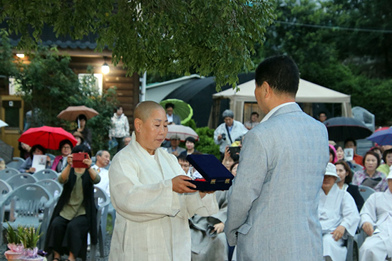 (사)향기로운동행 이사장 보혜스님이 부산국제차문화교류회 회장으로 선임된 최원형씨에게 임명장을 수여하고 있다.